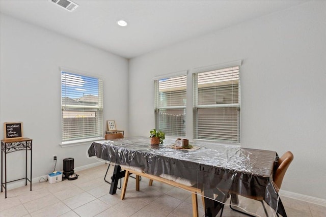 dining space featuring baseboards, a wealth of natural light, and visible vents
