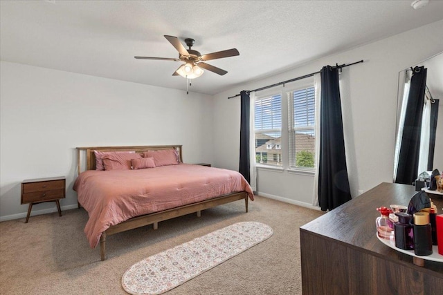 bedroom with carpet floors, baseboards, and a ceiling fan