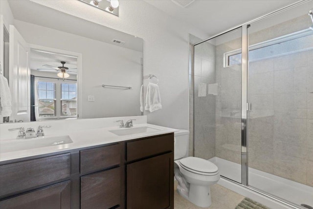 full bathroom with toilet, visible vents, a sink, and a stall shower