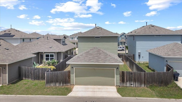 view of front of home featuring concrete driveway, a shingled roof, a residential view, and fence private yard