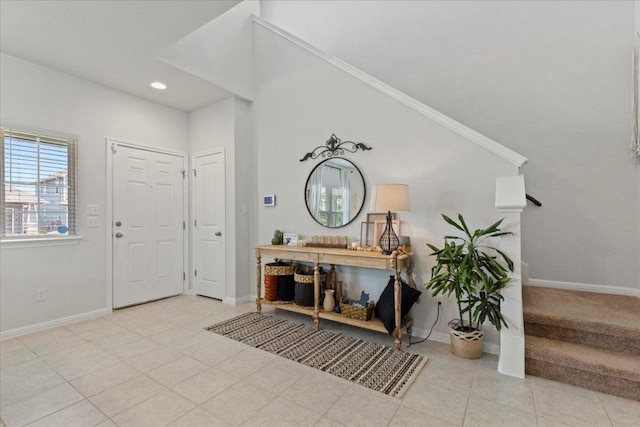 entryway featuring tile patterned floors, baseboards, stairway, and recessed lighting