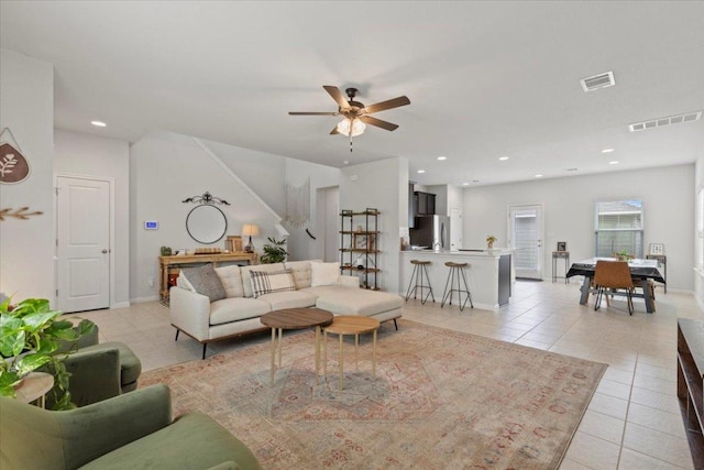 living area featuring light tile patterned floors, visible vents, ceiling fan, and recessed lighting