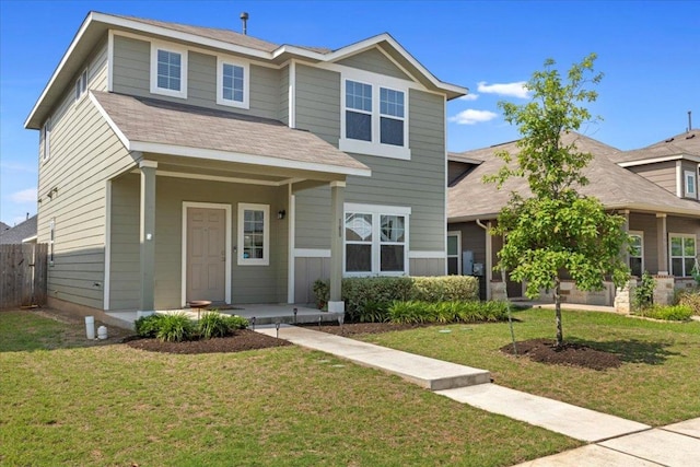 view of front of house with a porch, fence, and a front yard