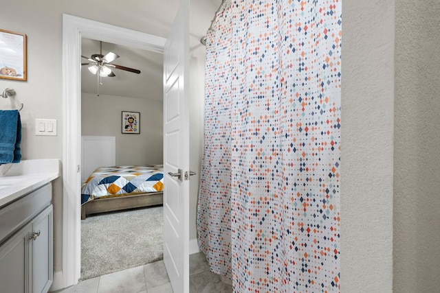 800 Kenney Fort Xing, Round Rock, TX 78665 - bathroom featuring ceiling fan, vanity, curtained shower, connected bathroom, and tile patterned floors