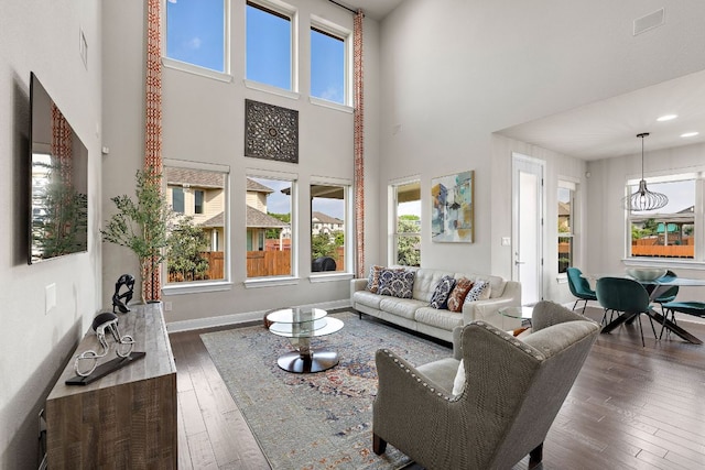 800 Kenney Fort Xing, Round Rock, TX 78665 - living room featuring a high ceiling, dark wood-type flooring, and baseboards
