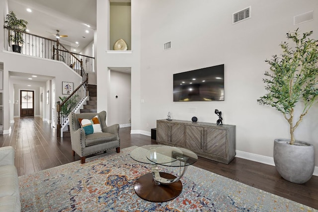 800 Kenney Fort Xing, Round Rock, TX 78665 - living area with baseboards, dark wood-style floors, a towering ceiling, ceiling fan, and stairs
