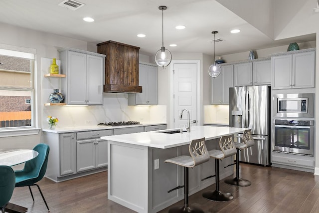 800 Kenney Fort Xing, Round Rock, TX 78665 - kitchen with stainless steel appliances, a sink, dark wood-style flooring, light countertops, and a kitchen bar