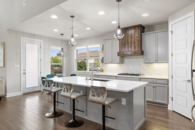 800 Kenney Fort Xing, Round Rock, TX 78665 - kitchen with a sink, stainless steel gas stovetop, a breakfast bar, recessed lighting, and dark wood finished floors