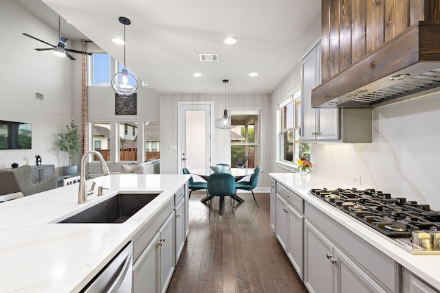 800 Kenney Fort Xing, Round Rock, TX 78665 - kitchen featuring a sink, under cabinet range hood, light countertops, open floor plan, and dark wood-style flooring