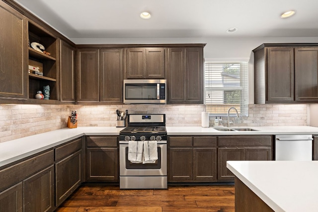 kitchen featuring stainless steel appliances, open shelves, a sink, and dark brown cabinets