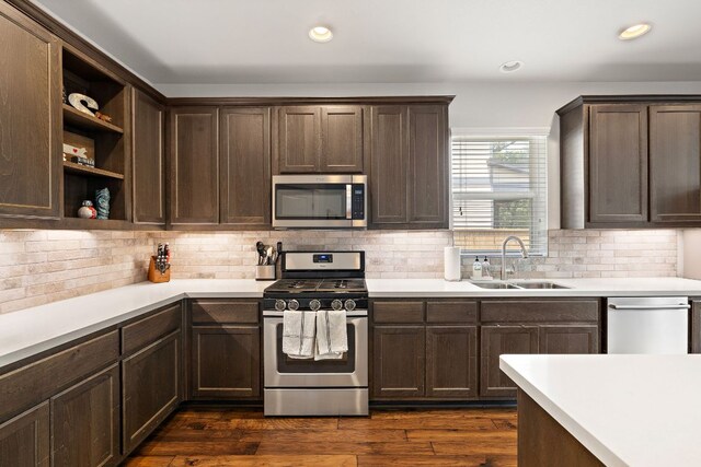 1403 Matthews Ln, Austin, TX 78745 - kitchen with appliances with stainless steel finishes, dark brown cabinetry, light countertops, and recessed lighting