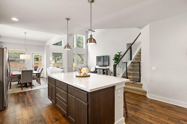 1403 Matthews Ln, Austin, TX 78745 - kitchen featuring freestanding refrigerator, dark brown cabinetry, dark wood-type flooring, open floor plan, and recessed lighting