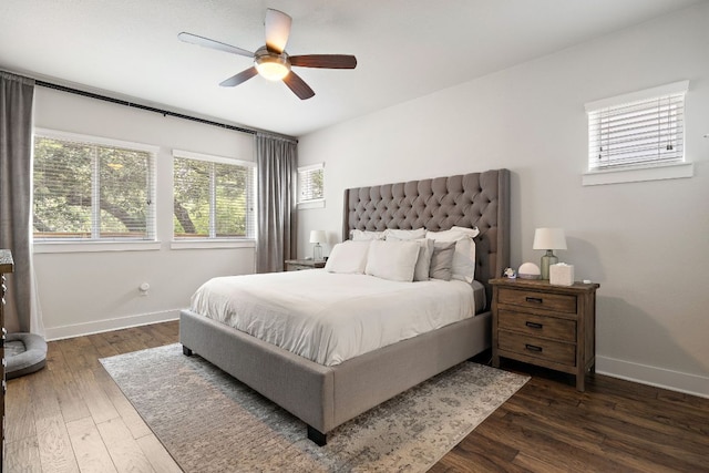 bedroom featuring baseboards, a ceiling fan, and dark wood finished floors