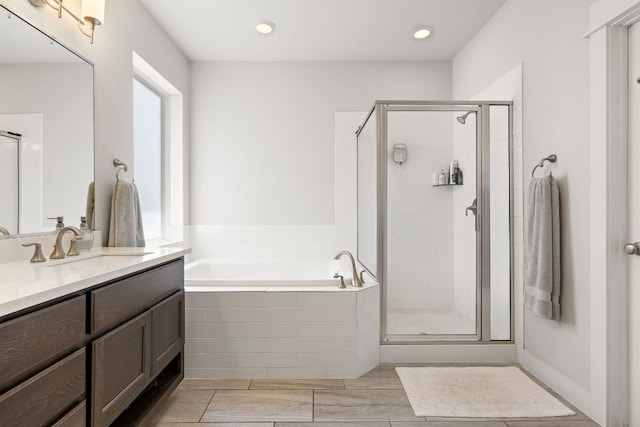 full bath with vanity, recessed lighting, a bath, and a stall shower