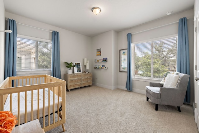 bedroom with carpet floors, baseboards, and multiple windows