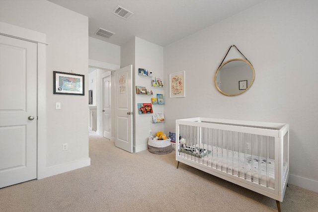 bedroom featuring carpet flooring, a nursery area, baseboards, and visible vents