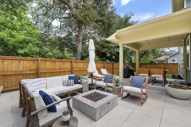 view of patio featuring a fenced backyard, an outdoor living space with a fire pit, outdoor dining area, and grilling area