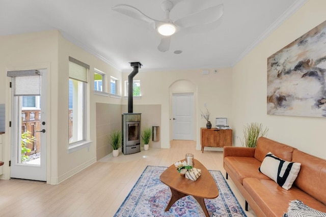 4128 E Lawless St, Austin, TX 78723 - living room with a wood stove, a ceiling fan, ornamental molding, wood finished floors, and arched walkways