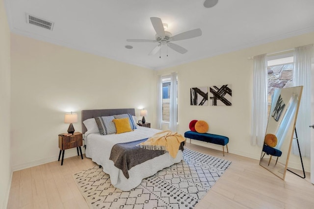 4128 E Lawless St, Austin, TX 78723 - bedroom featuring multiple windows, light wood-style floors, crown molding, and a ceiling fan
