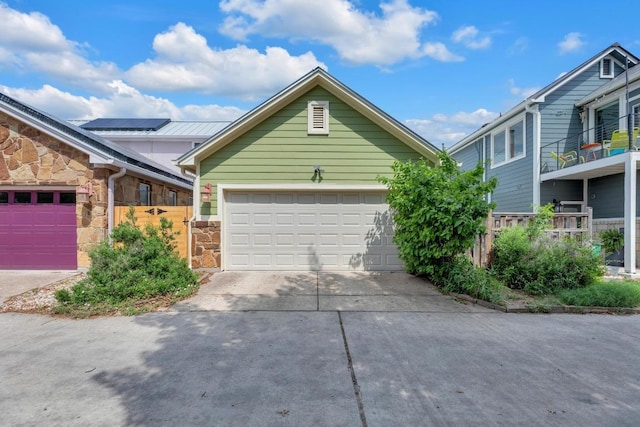 4128 E Lawless St, Austin, TX 78723 - view of front of home with stone siding, a garage, and concrete driveway