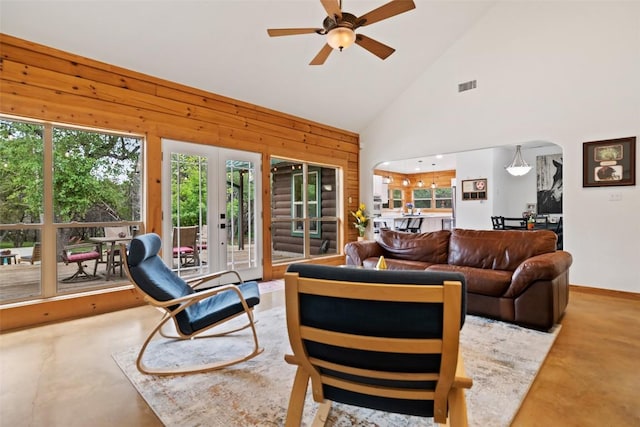 9854 N Weir Loop Cir, Austin, TX 78736 - living area featuring wooden walls, high vaulted ceiling, french doors, a ceiling fan, and visible vents