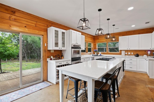 9854 N Weir Loop Cir, Austin, TX 78736 - kitchen with a kitchen bar, visible vents, plenty of natural light, and finished concrete flooring