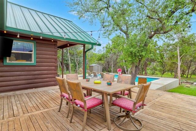 9854 N Weir Loop Cir, Austin, TX 78736 - wooden terrace with a storage shed, an outbuilding, an outdoor pool, and outdoor dining space