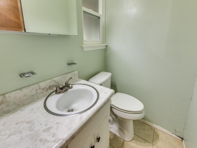817 Glen Oak Dr, Austin, TX 78745 - half bathroom featuring vanity, toilet, tile patterned floors, and baseboards