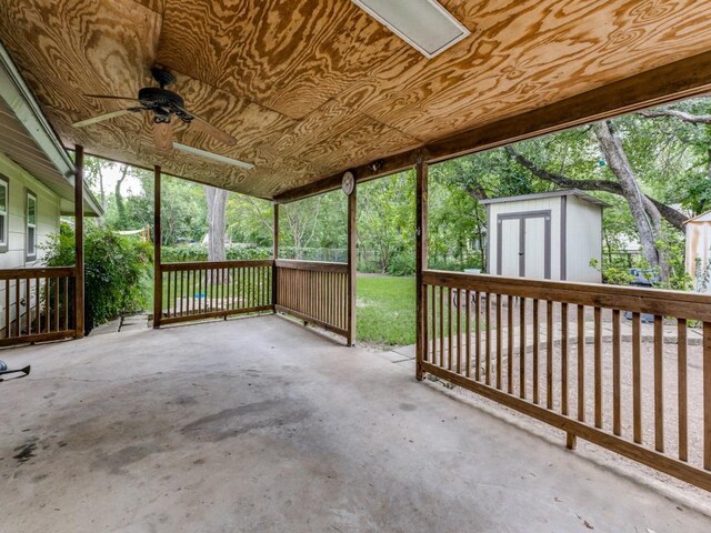 view of patio with a storage unit, an outdoor structure, and ceiling fan
