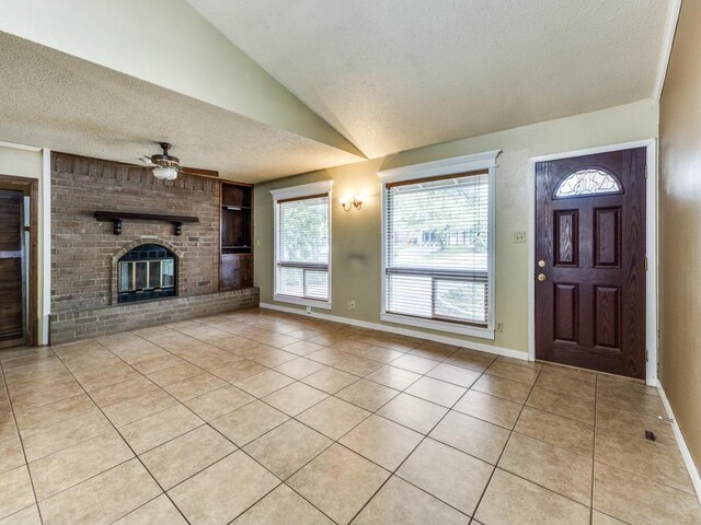 unfurnished living room with light tile patterned floors, built in features, a ceiling fan, and a textured ceiling