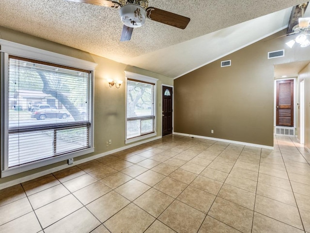 817 Glen Oak Dr, Austin, TX 78745 - unfurnished room featuring a ceiling fan, vaulted ceiling, light tile patterned floors, a textured ceiling, and baseboards