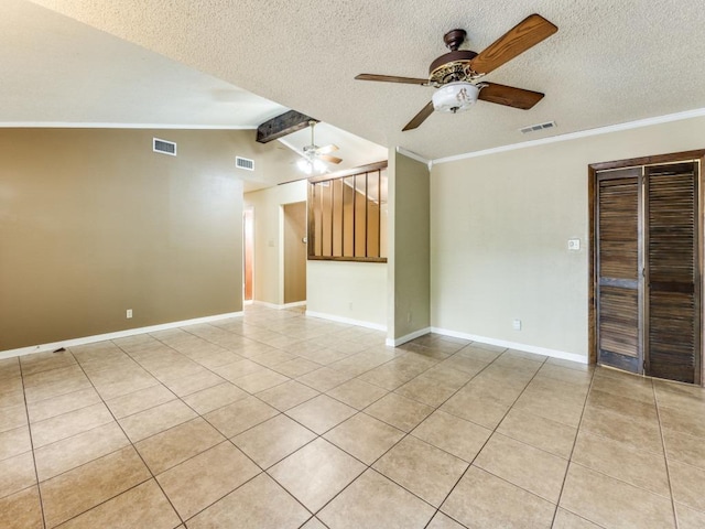 817 Glen Oak Dr, Austin, TX 78745 - spare room featuring a ceiling fan, light tile patterned floors, a textured ceiling, crown molding, and baseboards