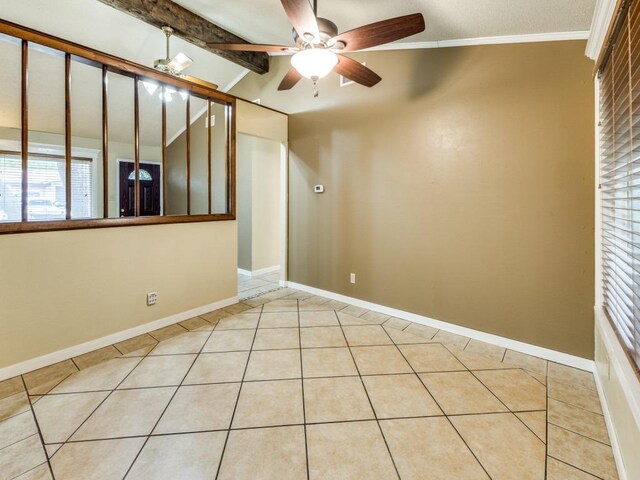 empty room with baseboards, light tile patterned floors, a ceiling fan, and vaulted ceiling with beams