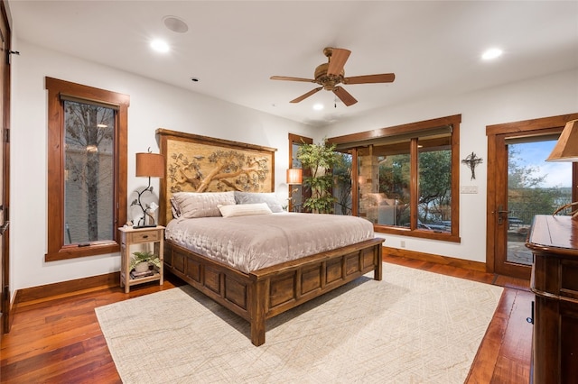 bedroom featuring recessed lighting, baseboards, access to exterior, and wood finished floors