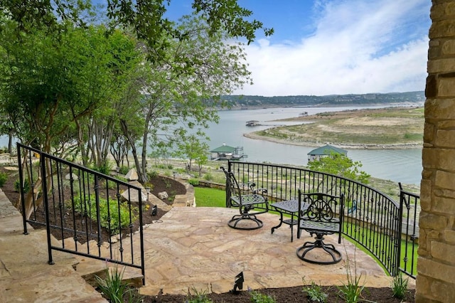 view of patio with a water view