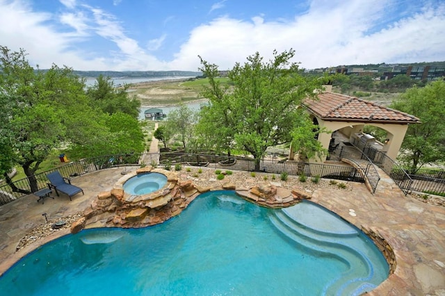 view of pool with fence, a fenced in pool, an in ground hot tub, and a patio area