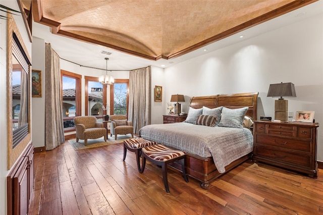 bedroom with baseboards, a notable chandelier, dark wood finished floors, and visible vents