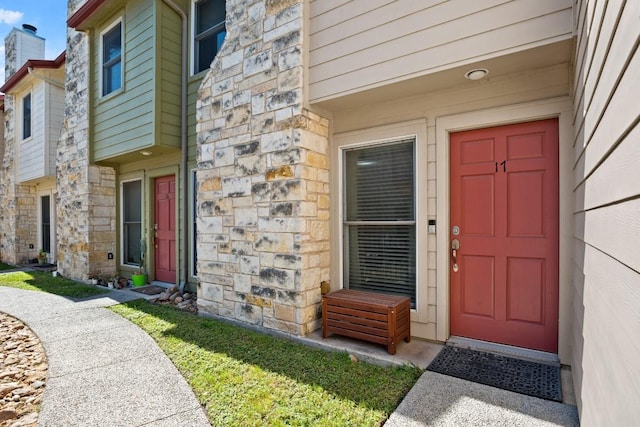 6900 E Riverside Dr Unit 17, Austin, TX 78741 - doorway to property with stone siding