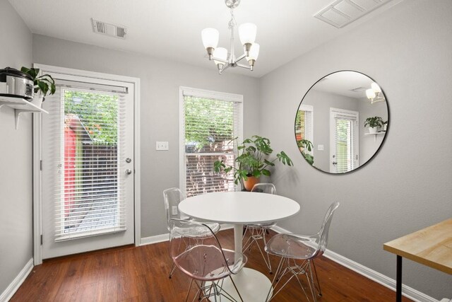 dining area featuring visible vents, baseboards, wood finished floors, and a wealth of natural light