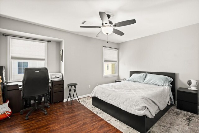 bedroom with baseboards, ceiling fan, and wood finished floors