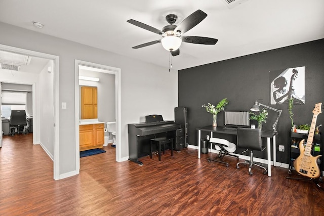 office space with visible vents, wood finished floors, baseboards, attic access, and ceiling fan