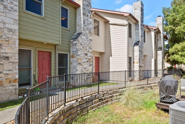 6900 E Riverside Dr Unit 17, Austin, TX 78741 - exterior space featuring a chimney and stone siding