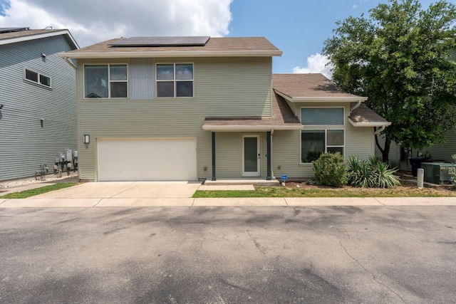 301 W Stassney Ln Unit 3, Austin, TX 78745 - view of front of house with roof mounted solar panels, a garage, and driveway