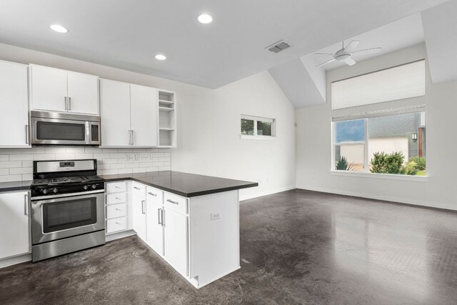 kitchen featuring stainless steel appliances, dark countertops, visible vents, and concrete floors