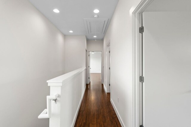 hall with attic access, recessed lighting, baseboards, an upstairs landing, and wood finished floors