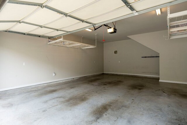 garage featuring baseboards and a garage door opener