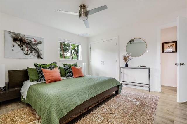 bedroom with a ceiling fan and light wood-type flooring