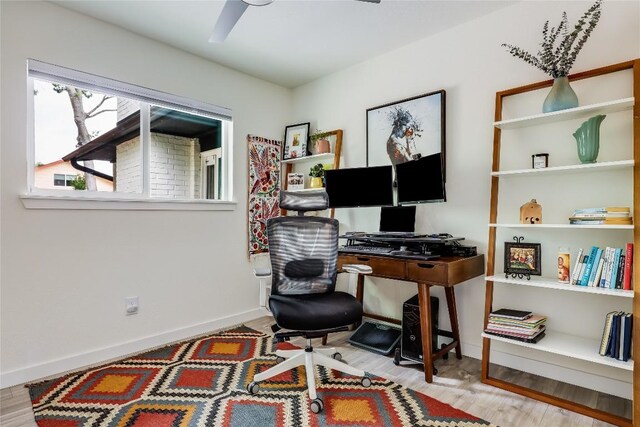 home office with baseboards and wood finished floors