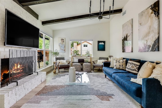 1415 Mearns Meadow Blvd, Austin, TX 78758 - living room featuring wood finished floors, a fireplace, and beamed ceiling