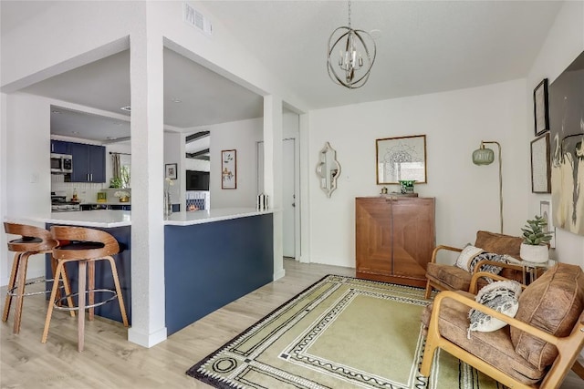 1415 Mearns Meadow Blvd, Austin, TX 78758 - living room with light wood-style flooring and a chandelier
